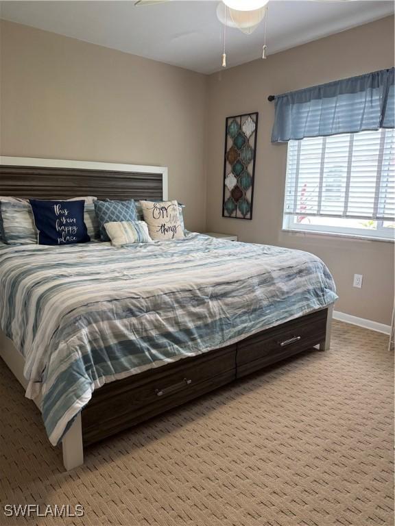 190 N Collier Blvd Unit O4, Marco Island, FL 34145 - carpeted bedroom featuring baseboards and ceiling fan
