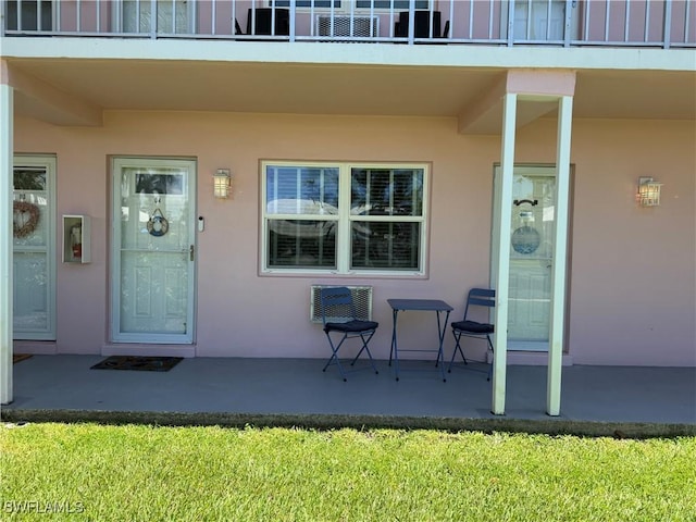 190 N Collier Blvd Unit O4, Marco Island, FL 34145 - view of exterior entry with stucco siding, a patio, and a balcony