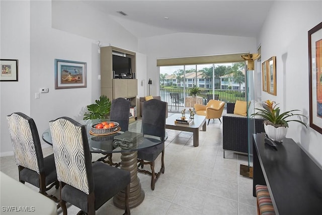 6275 Wilshire Pines Cir Unit 1008, Naples, FL 34109 - dining room featuring lofted ceiling and light tile patterned floors