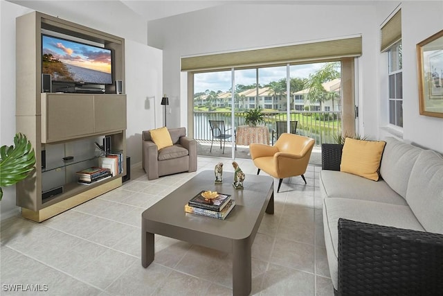 6275 Wilshire Pines Cir Unit 1008, Naples, FL 34109 - living area with vaulted ceiling, plenty of natural light, and light tile patterned floors