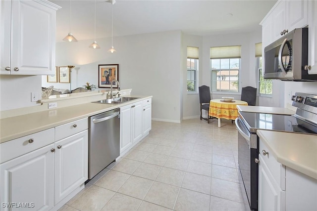 6275 Wilshire Pines Cir Unit 1008, Naples, FL 34109 - kitchen featuring appliances with stainless steel finishes, light countertops, light tile patterned floors, and white cabinetry