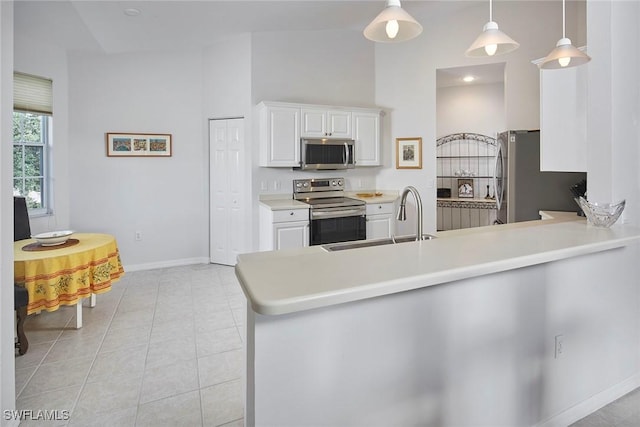 6275 Wilshire Pines Cir Unit 1008, Naples, FL 34109 - kitchen with stainless steel appliances, white cabinetry, a peninsula, light countertops, and pendant lighting