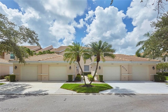 6275 Wilshire Pines Cir Unit 1008, Naples, FL 34109 - view of front facade with a tiled roof and stucco siding