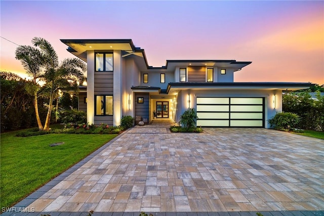 1261 13th Ave N, Naples, FL 34102 - view of front of home with decorative driveway, a front yard, french doors, and stucco siding