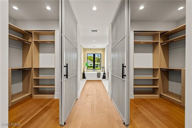 1261 13th Ave N, Naples, FL 34102 - walk in closet with light wood-type flooring