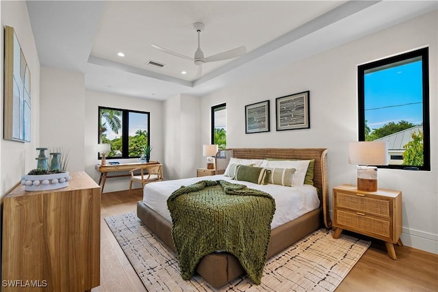 1261 13th Ave N, Naples, FL 34102 - bedroom with light wood-type flooring, a tray ceiling, recessed lighting, and ceiling fan