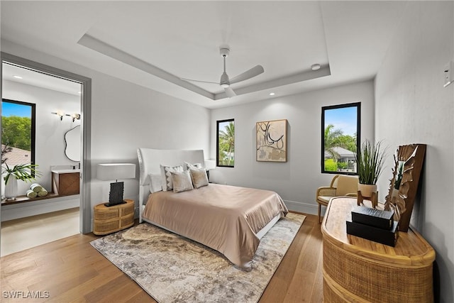 1261 13th Ave N, Naples, FL 34102 - bedroom with a tray ceiling, wood finished floors, ceiling fan, and recessed lighting