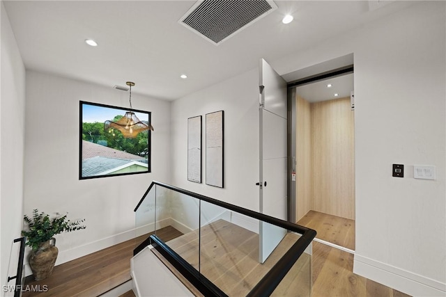 1261 13th Ave N, Naples, FL 34102 - stairway with recessed lighting, wood finished floors, and elevator