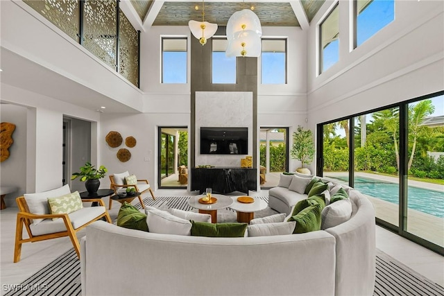 1261 13th Ave N, Naples, FL 34102 - living room featuring a towering ceiling and a fireplace