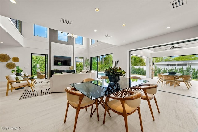 1261 13th Ave N, Naples, FL 34102 - dining room with recessed lighting, a ceiling fan, and a towering ceiling