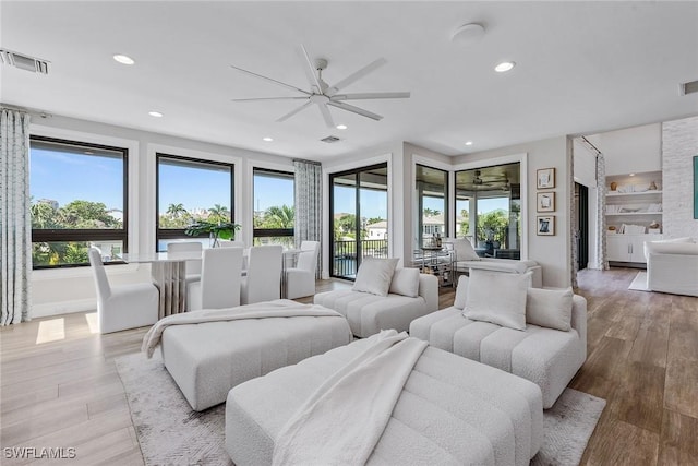 434 Trade Winds Ave, Naples, FL 34108 - living room with a ceiling fan, light wood-style flooring, and recessed lighting