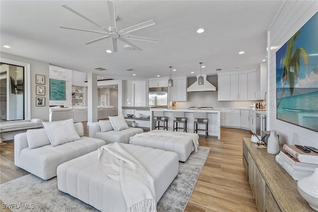434 Trade Winds Ave, Naples, FL 34108 - living room featuring ceiling fan, light wood-style floors, and recessed lighting