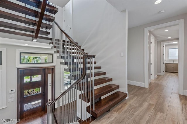 434 Trade Winds Ave, Naples, FL 34108 - stairway with wood finished floors, recessed lighting, and plenty of natural light