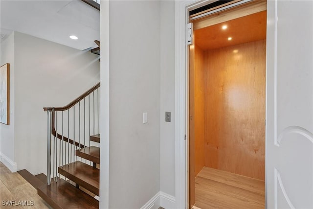 434 Trade Winds Ave, Naples, FL 34108 - stairs with wood finished floors, elevator, and recessed lighting