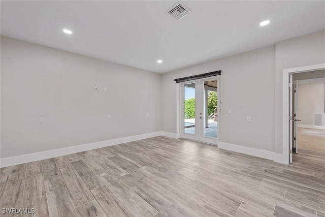 434 Trade Winds Ave, Naples, FL 34108 - empty room with french doors, light wood finished floors, and recessed lighting