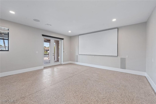 434 Trade Winds Ave, Naples, FL 34108 - home theater room with plenty of natural light, recessed lighting, french doors, and speckled floor