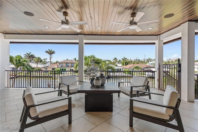 434 Trade Winds Ave, Naples, FL 34108 - view of patio with an outdoor hangout area, a ceiling fan, and a water view