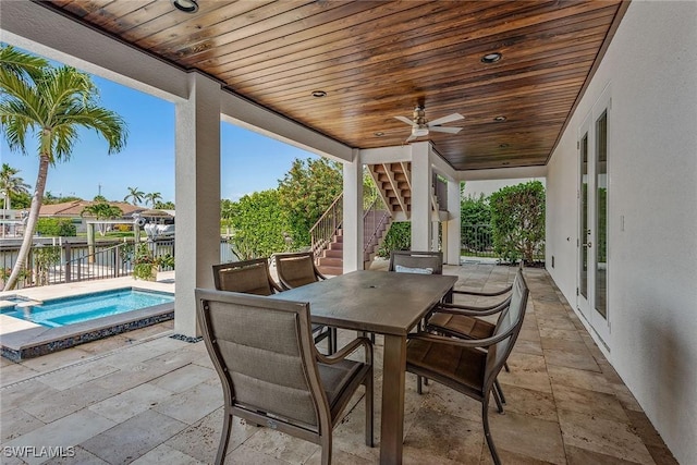 434 Trade Winds Ave, Naples, FL 34108 - view of patio / terrace with stairway, outdoor dining area, a ceiling fan, and a pool with connected hot tub