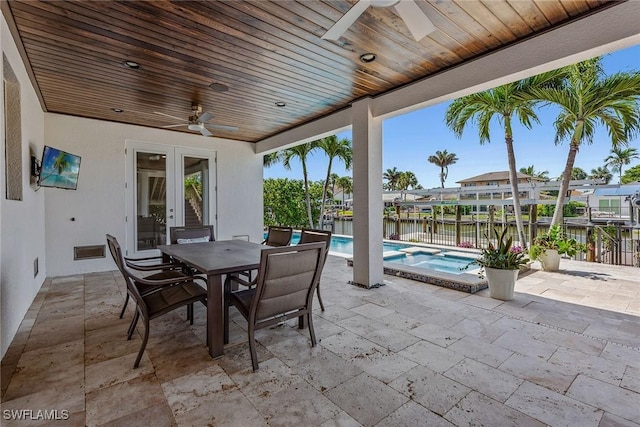 434 Trade Winds Ave, Naples, FL 34108 - view of patio / terrace with a ceiling fan, french doors, outdoor dining space, a pool with connected hot tub, and a water view