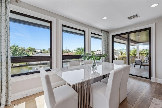 434 Trade Winds Ave, Naples, FL 34108 - dining area featuring wood finished floors and recessed lighting