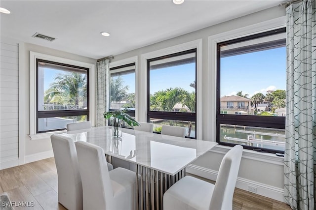 434 Trade Winds Ave, Naples, FL 34108 - dining area with wood finished floors and recessed lighting