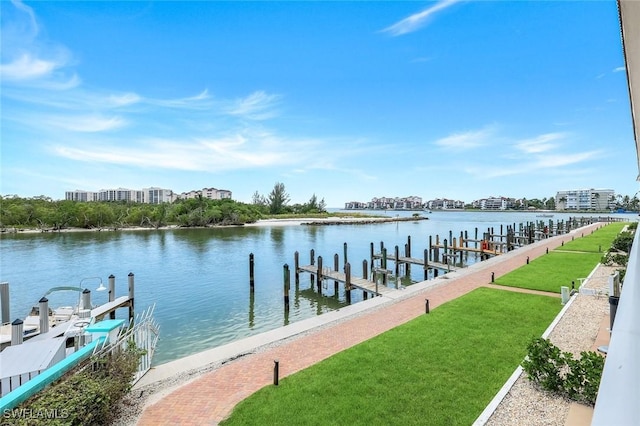 1208 Edington Pl Unit E204, Marco Island, FL 34145 - dock area featuring a water view and a lawn