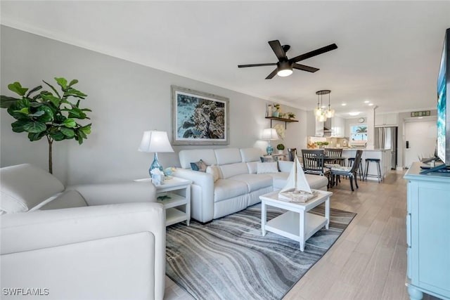 1208 Edington Pl Unit E204, Marco Island, FL 34145 - living room with ceiling fan, light wood finished floors, crown molding, and a chandelier