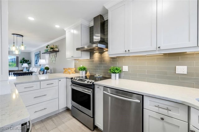 1208 Edington Pl Unit E204, Marco Island, FL 34145 - kitchen featuring stainless steel appliances, wall chimney exhaust hood, ornamental molding, white cabinetry, and backsplash