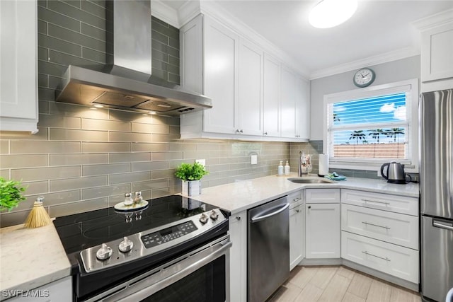 1208 Edington Pl Unit E204, Marco Island, FL 34145 - kitchen featuring wall chimney exhaust hood, stainless steel appliances, white cabinetry, ornamental molding, and backsplash