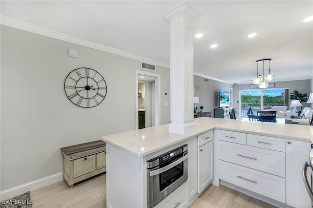 1208 Edington Pl Unit E204, Marco Island, FL 34145 - kitchen with ornate columns, light wood-type flooring, ornamental molding, open floor plan, and white cabinetry