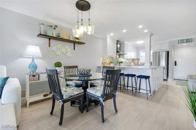 1208 Edington Pl Unit E204, Marco Island, FL 34145 - dining room featuring crown molding, light wood finished floors, recessed lighting, and ornate columns