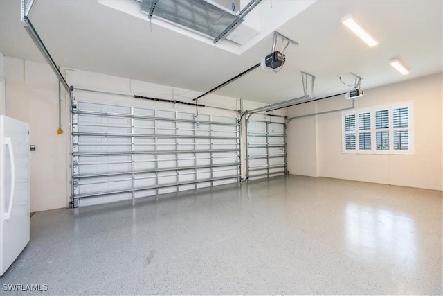 9088 Caicos Way, Naples, FL 34114 - garage featuring freestanding refrigerator and a garage door opener