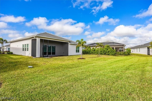 9088 Caicos Way, Naples, FL 34114 - back of property featuring stucco siding and a lawn