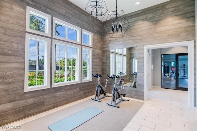 9088 Caicos Way, Naples, FL 34114 - workout room featuring a chandelier, tile patterned floors, and plenty of natural light