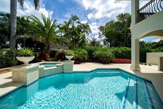 33 3rd St S, Naples, FL 34102 - view of pool with a patio area and a pool with connected hot tub