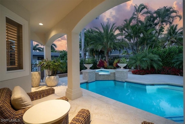 33 3rd St S, Naples, FL 34102 - pool at dusk with a patio area and a pool with connected hot tub