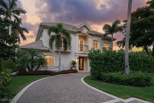 33 3rd St S, Naples, FL 34102 - mediterranean / spanish-style home with a balcony, stucco siding, and curved driveway