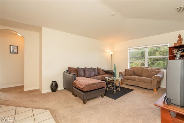 5201/5203 26th St SW, Lehigh Acres, FL 33973 - carpeted living area featuring arched walkways and tile patterned flooring