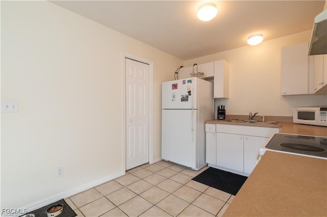 5201/5203 26th St SW, Lehigh Acres, FL 33973 - kitchen with white appliances, white cabinets, exhaust hood, and light tile patterned flooring