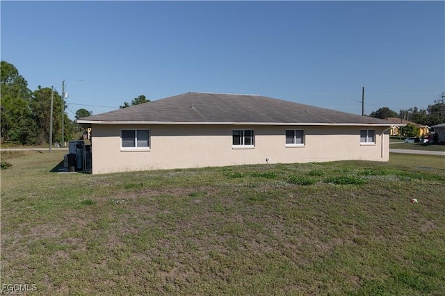 5201/5203 26th St SW, Lehigh Acres, FL 33973 - view of side of property featuring a lawn and stucco siding
