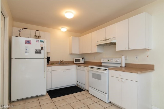 5201/5203 26th St SW, Lehigh Acres, FL 33973 - kitchen featuring white appliances, under cabinet range hood, white cabinetry, and light tile patterned flooring