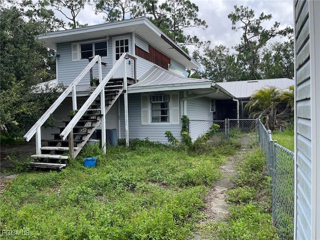 6292 Morgan La Fee Ln, Fort Myers, FL 33912 - rear view of house featuring stairs and a metal roof