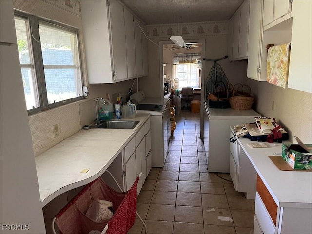 6292 Morgan La Fee Ln, Fort Myers, FL 33912 - kitchen featuring light countertops, white cabinetry, wallpapered walls, a ceiling fan, and light tile patterned floors