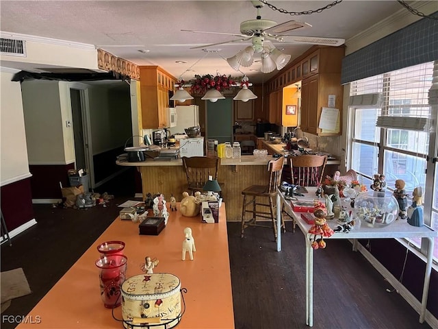 6292 Morgan La Fee Ln, Fort Myers, FL 33912 - dining space featuring a ceiling fan, crown molding, and wood finished floors