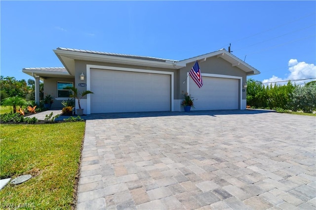 view of front of home with a front lawn and a garage