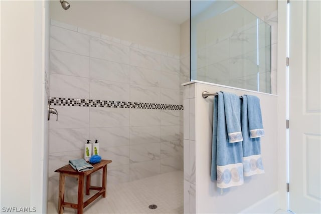 bathroom featuring a shower with shower door