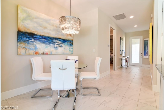 tiled dining space with a chandelier