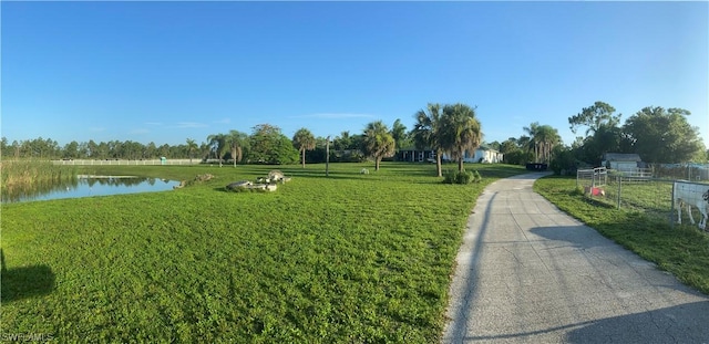 view of property's community featuring a yard and a water view