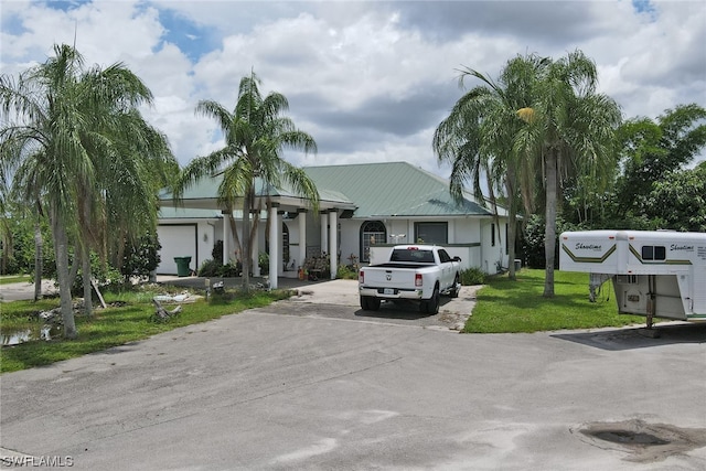 view of front of house with a front yard and a garage