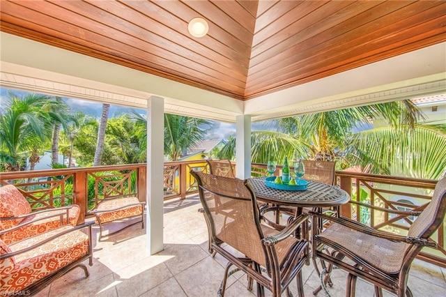 sunroom / solarium featuring vaulted ceiling and wooden ceiling